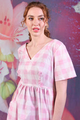 Model wearing the Annah Stretton Saski Angel Dress in pink check